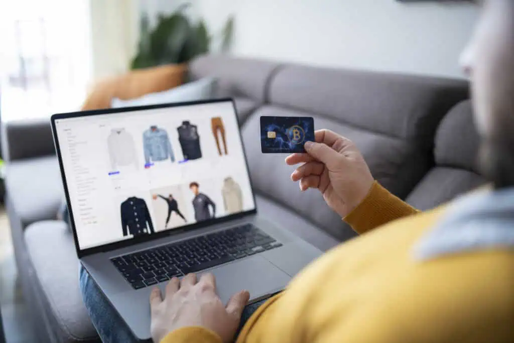 Man using credit card to shop online from home.