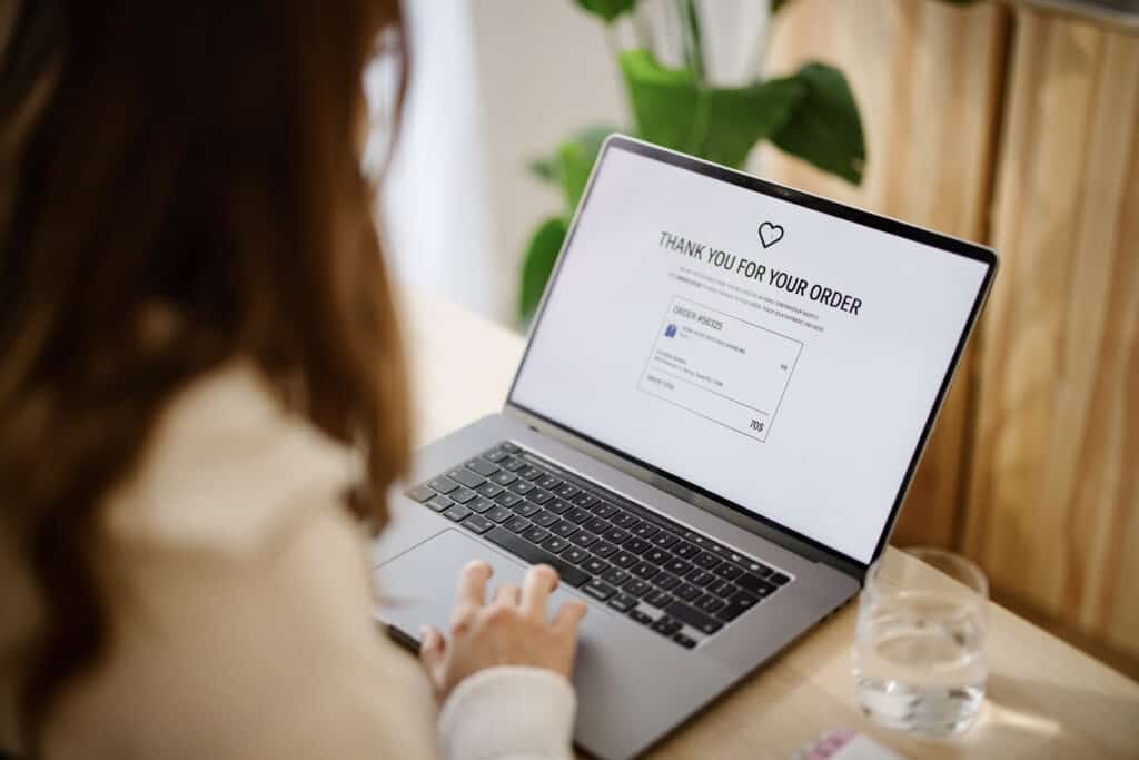 Woman online shopping fashion clothes at home