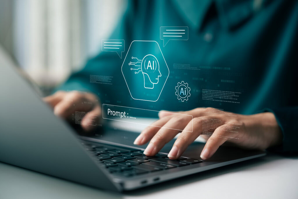 Person using laptop with AI and chatbot icons overlayed on screen.