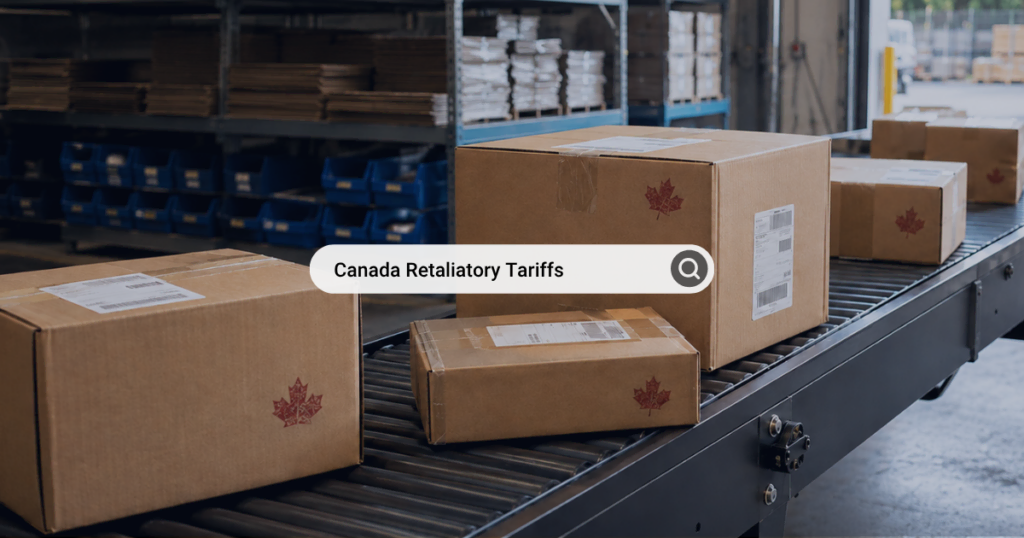 Boxes with Canadian maple leaf logo on a conveyor belt in a warehouse.